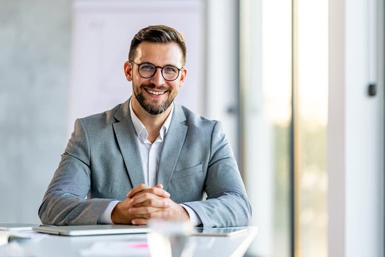 Man in suit smiling at off-camera client